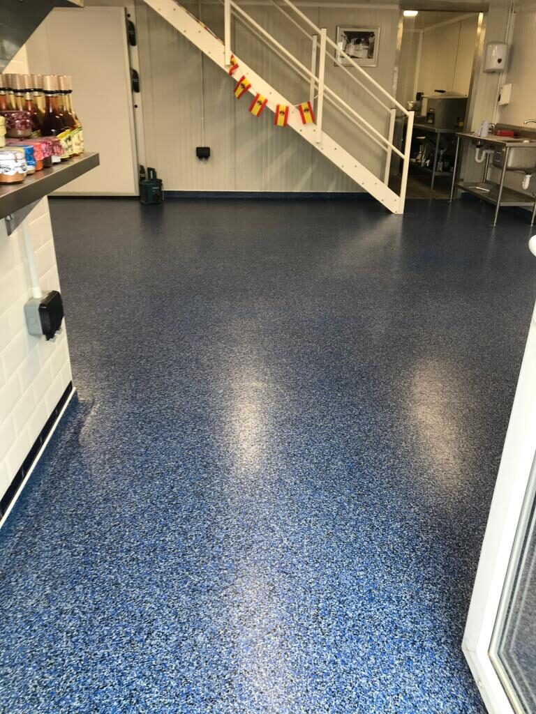 Blue decorative flake resin floor in a commercial room