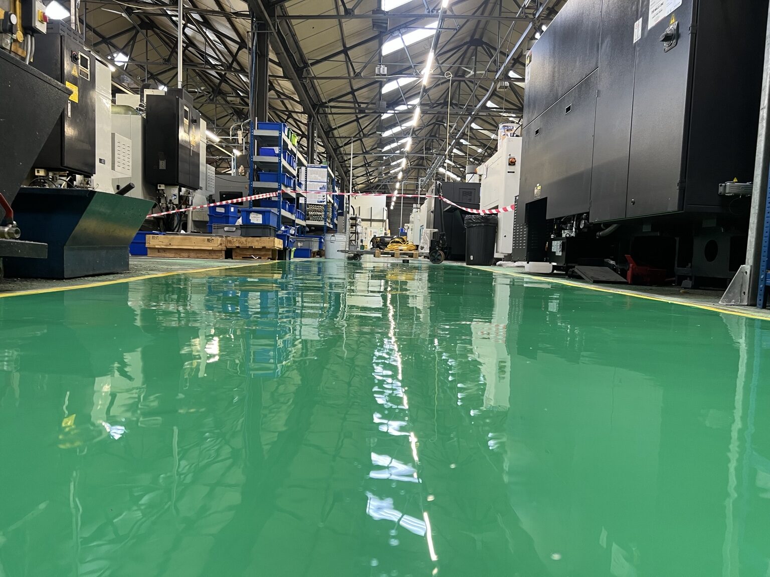 Glossy green resin floor in a working factory